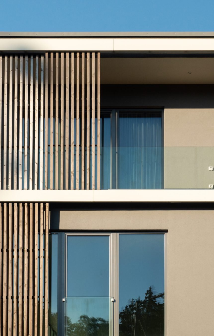 New modern residential building with balcony against blue sky. Housing construction concept. Elite residential building.