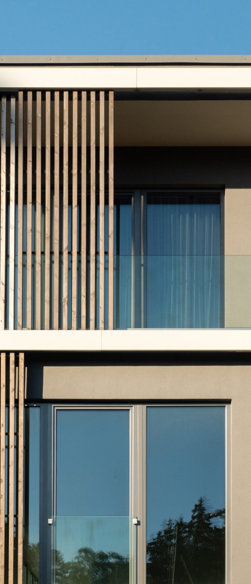 New modern residential building with balcony against blue sky. Housing construction concept. Elite residential building.